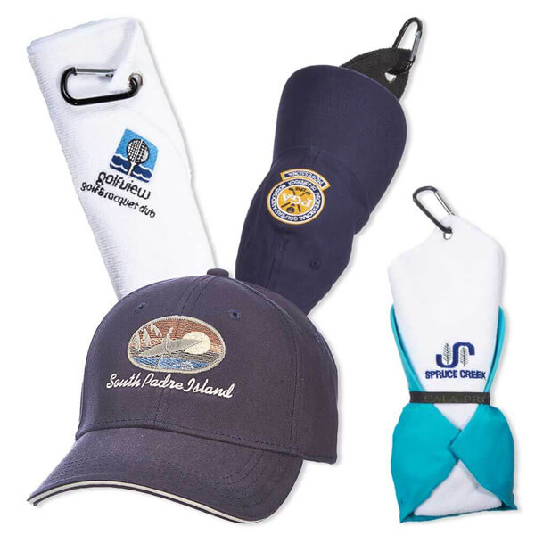 Two navy blue hats and two white towels with embroidered graphics on the front