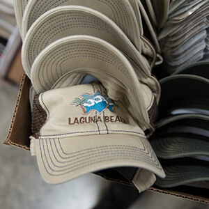 Embroidered caps stacked in a box