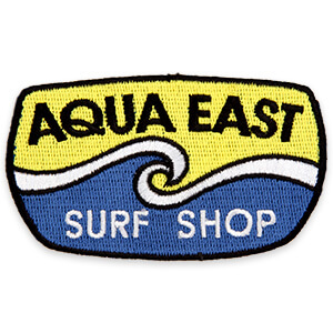Aqua East Surf Shop with blue and yellow waves patch