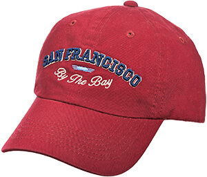 Red unstructured cap with blue embroidered artwork on the front